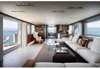 Looking aft in the main saloon with its folding balcony and open air lounge area aft