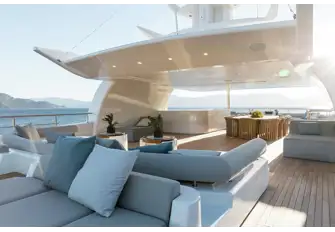 Dining and a fully equipped bar under the spacious sun deck's hardtop, seating forward, sun lounge and sunpads aft