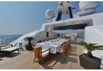 Looking forward on the sun deck across dining, bar and BBQ to the raised lounge area