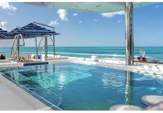 A large sun deck pool with swim-up bar...