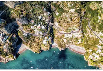 The coast is studded with small coves and towns, linked by the winding cliff-edge road