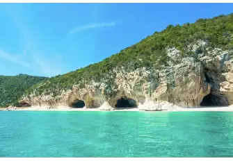 Sail past the cliffs and caves that edge this National Park