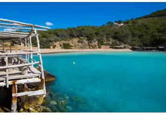 Beautiful turquoise water laps the pebbles at Cala Benirras