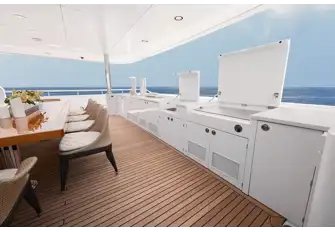 Open-air dining on the main deck aft with its food station