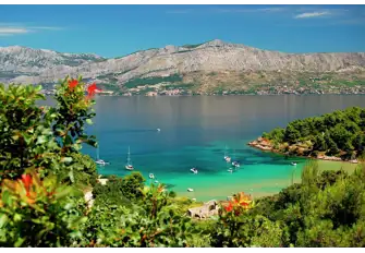 Sheltered Lovrečina beach on the island's northern coast, with the mountainous mainland across the water