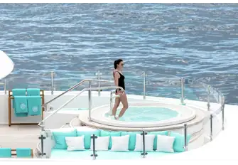 Soak up the sun and sip on a cocktail as you relax in the yacht's sun deck jacuzzi