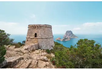 The Torre des Savinar with Es Vedrà offshore. There are some spectacular sunsets here