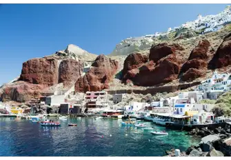 Ammoudi is a lively fishing village at the foot of the distinctive red cliffs below the historic town of Oia, Santorini