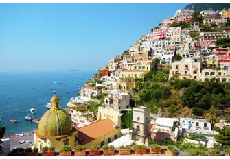 The unmistakable dome of Chiesa di Santa Maria Assunta nestles deep in the valley of Positano